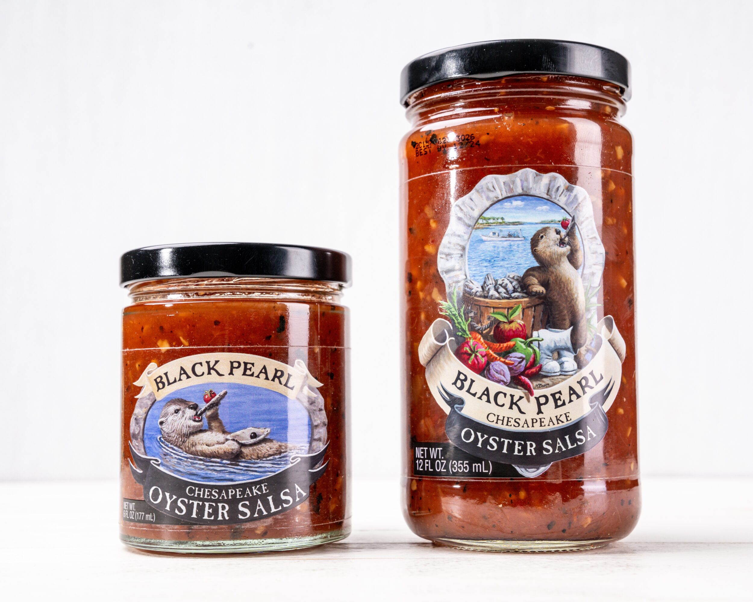 Two jars of oyster sauce with labels featuring a bear and a boat, placed on a white surface.