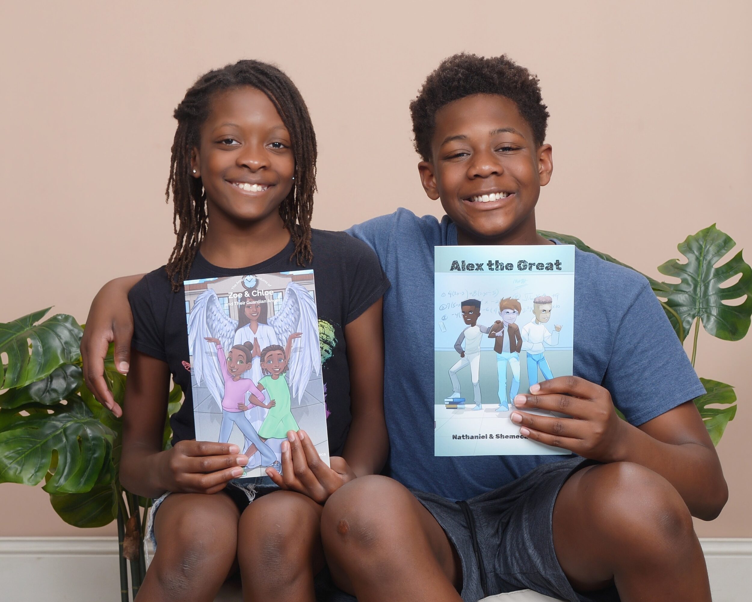 Two children sit side by side, smiling, each holding a book, with plants in the background.