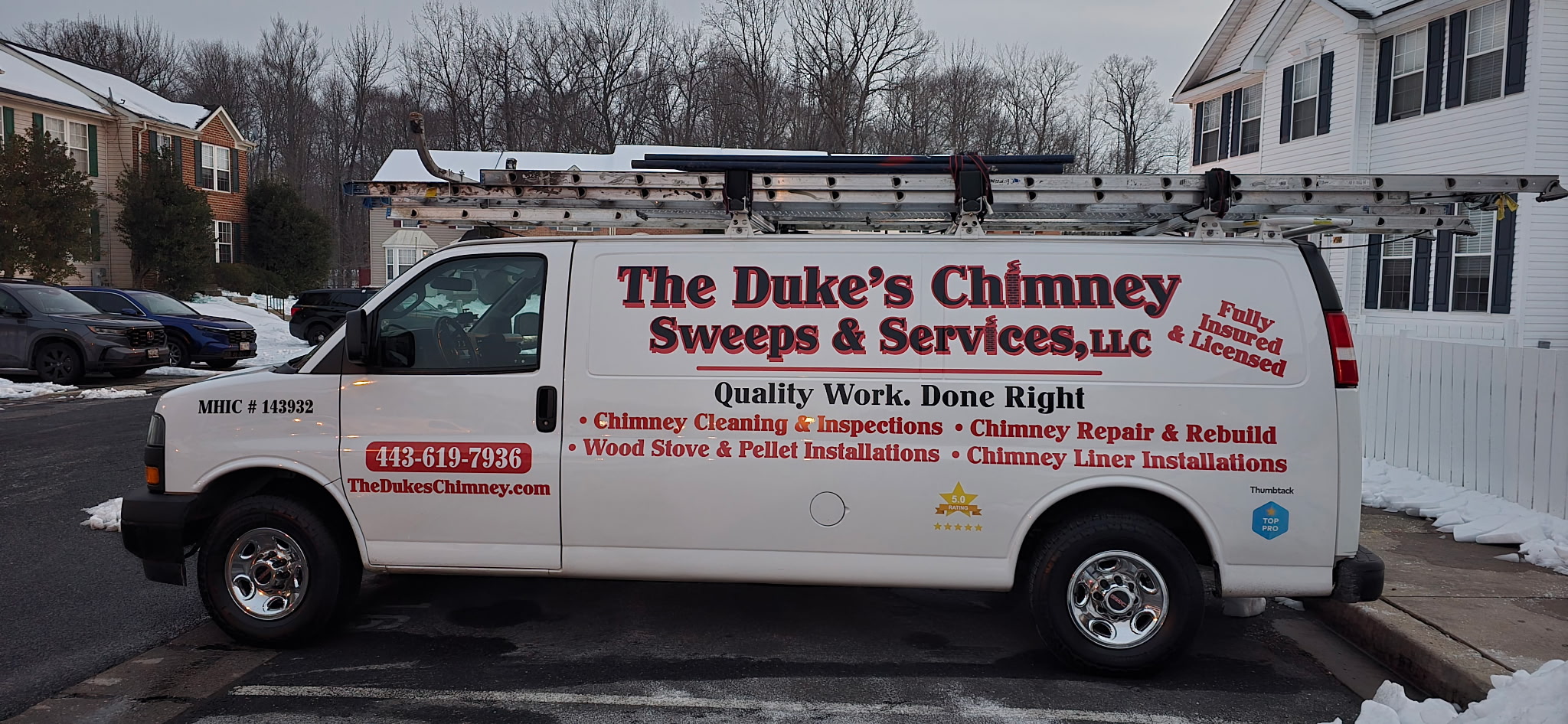Service van with red and black text advertising chimney sweeping and repair, parked on a street with houses and trees in background.