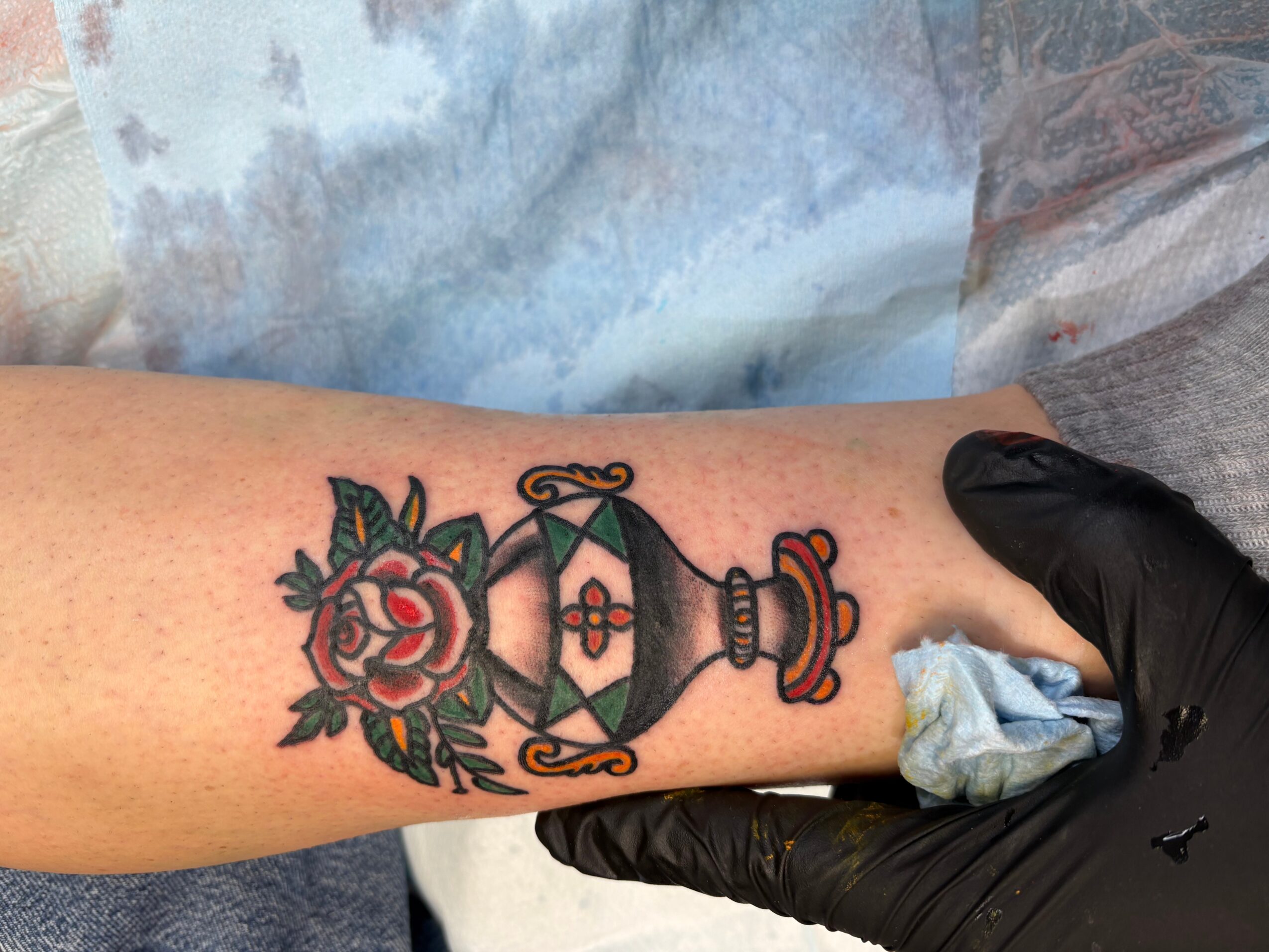 Tattoo of a traditional-style lantern with floral and decorative elements on a person's forearm.