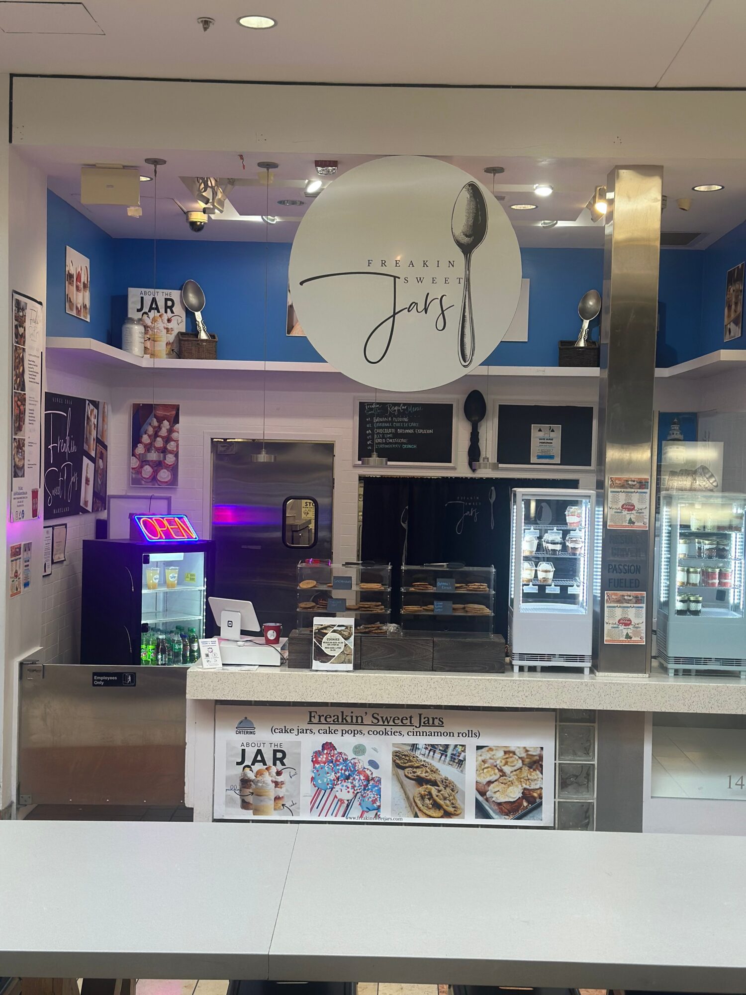 Counter service area with a large white balloon, menu displays, and a soda fountain, in a modern setting.