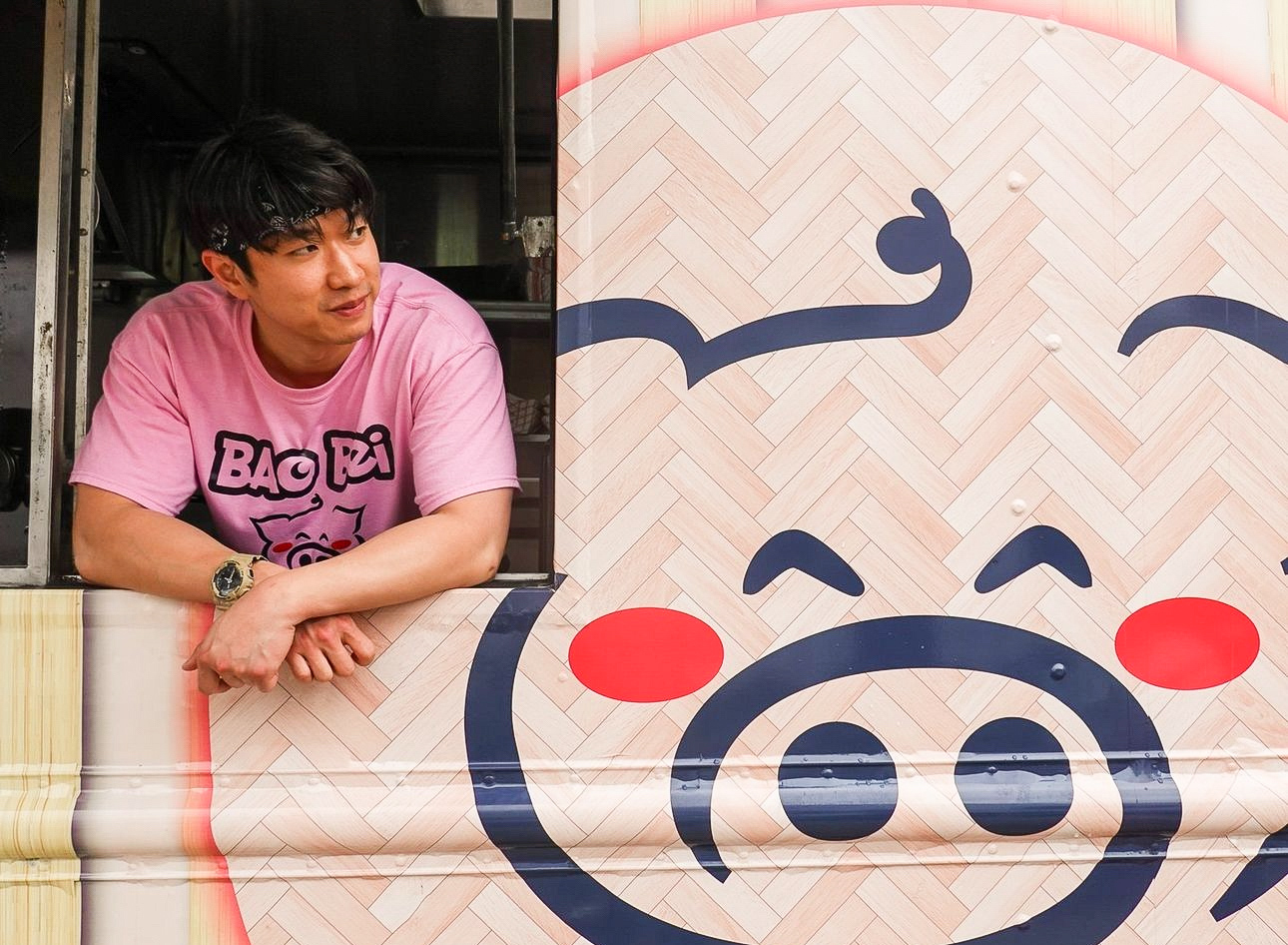 Person in pink shirt leaning on a window ledge, looking to the side, with a large cartoon pig face in the background.
