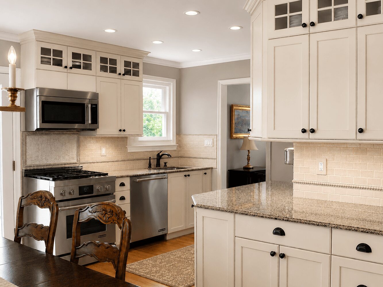 Kitchen with white cabinets, granite countertops, stainless steel appliances, and a window above the sink.