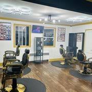 Room with chairs, tables, and a glass display case, illuminated ceiling, and windows with yellow trim.